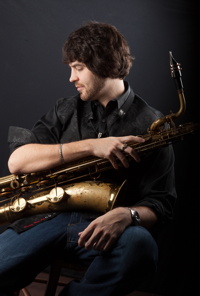 Photograph of Brian Landrus with baritone sax.