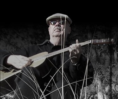 Photograph of composer Gary Edwards with a guitar
